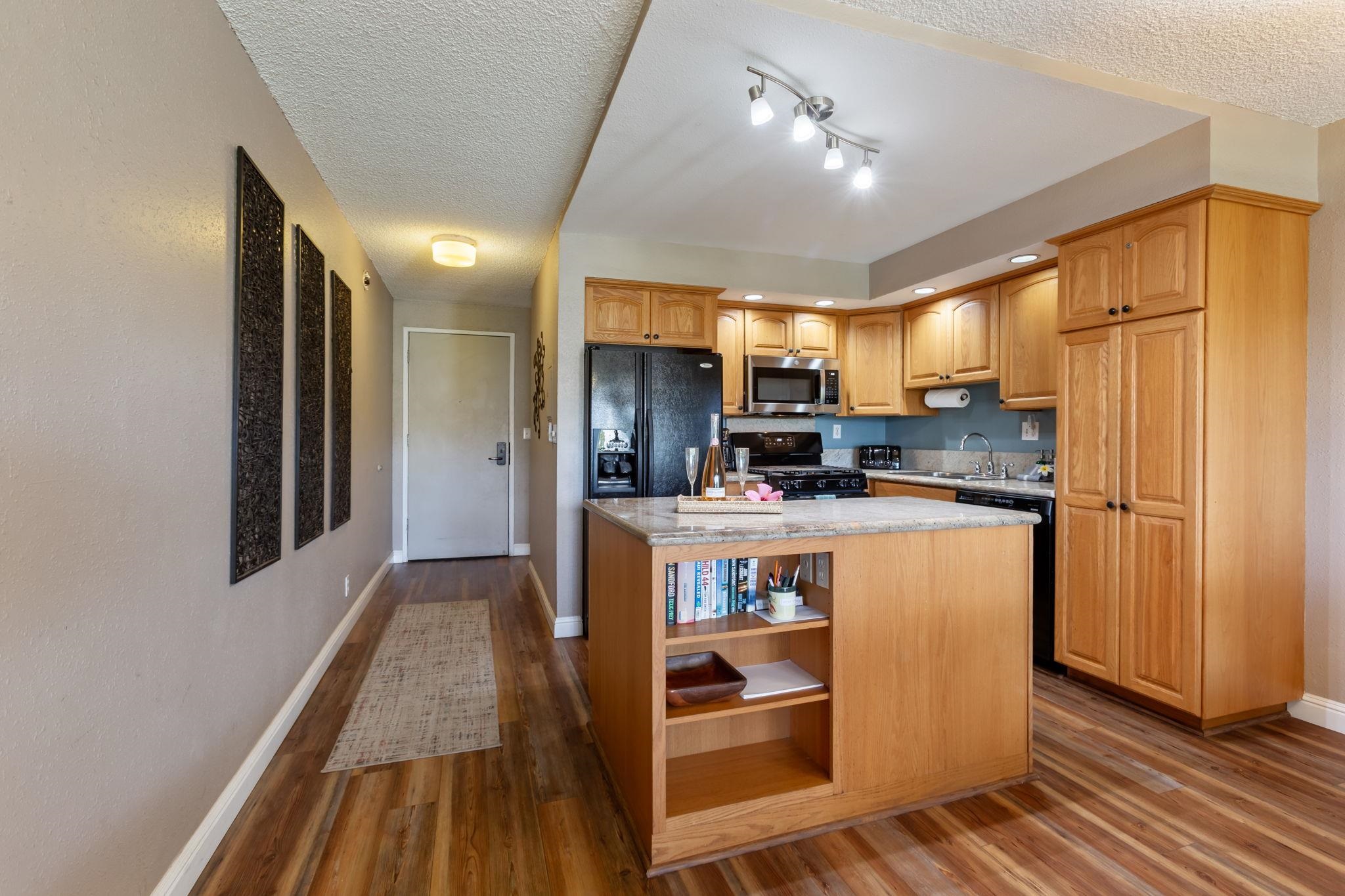2531 South Kihei Road, Unit C414 Kihei, HI 96753 - Photo 18 of 47 a kitchen with stainless steel appliances granite countertop a refrigerator and a stove top oven