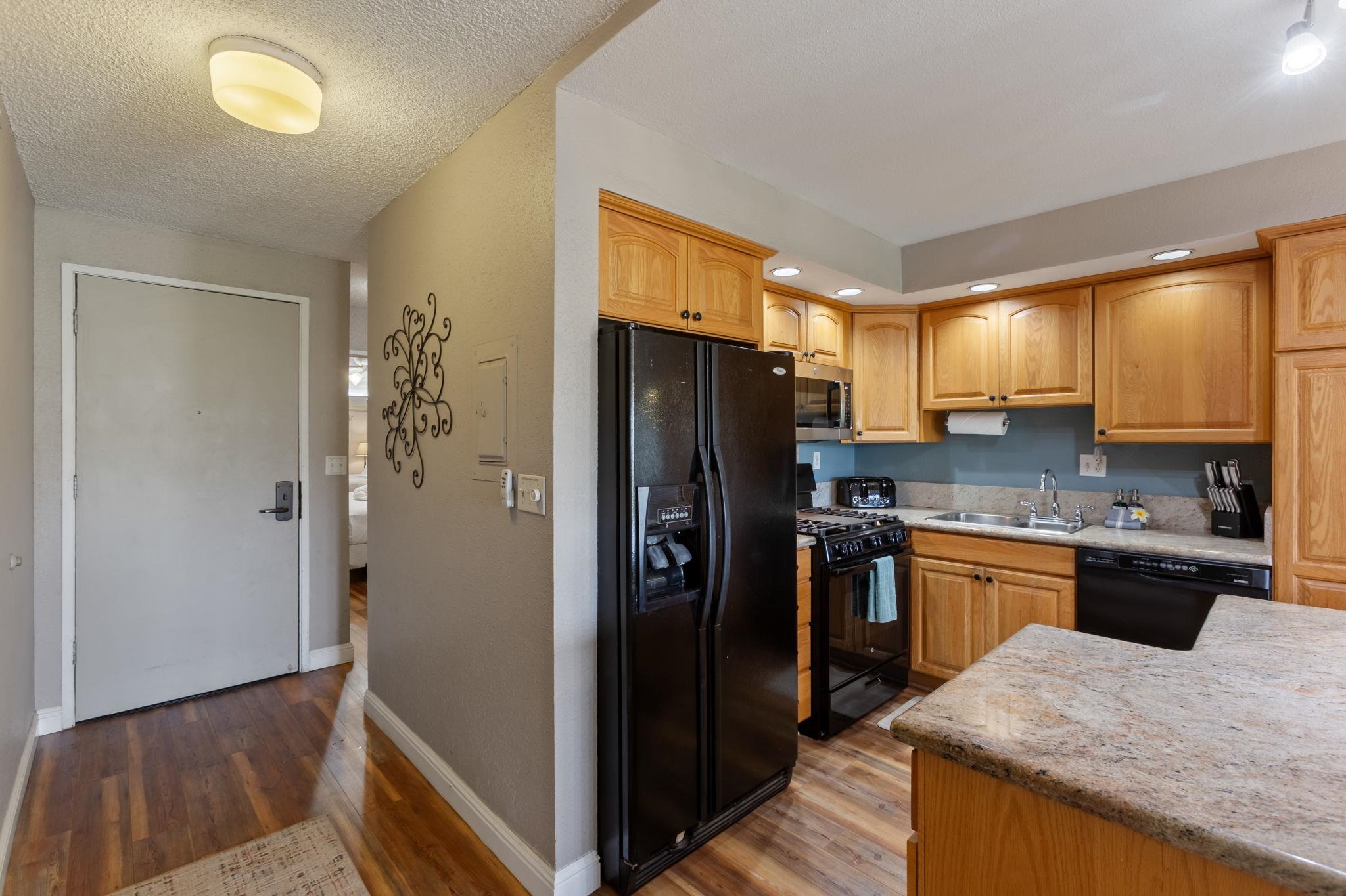 2531 South Kihei Road, Unit C414 Kihei, HI 96753 - Photo 19 of 47 a kitchen with granite countertop stainless steel appliances a refrigerator a stove a sink a counter space and cabinets
