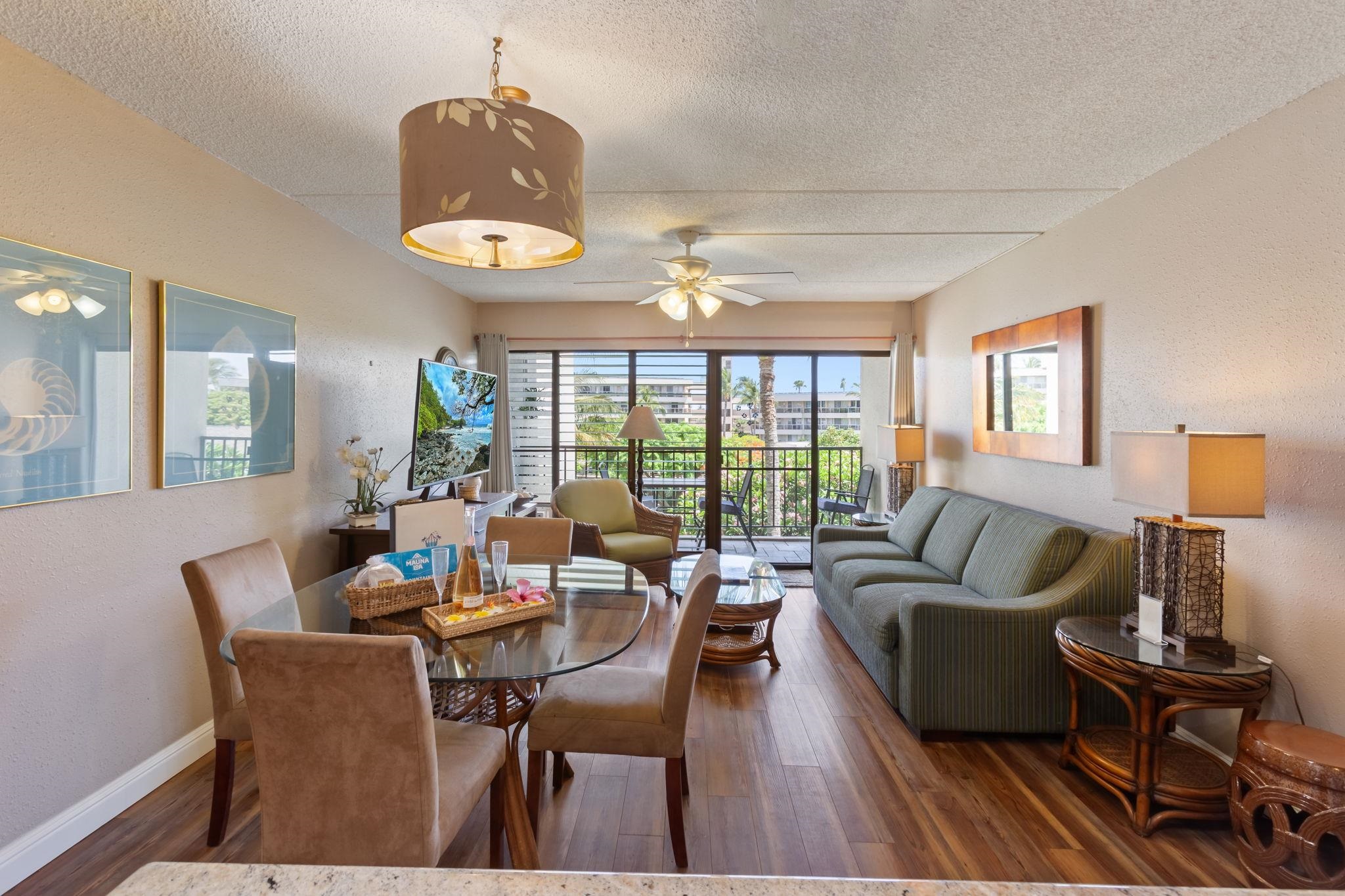 2531 South Kihei Road, Unit C414 Kihei, HI 96753 - Photo 2 of 47 a dining room with furniture a chandelier and wooden floor
