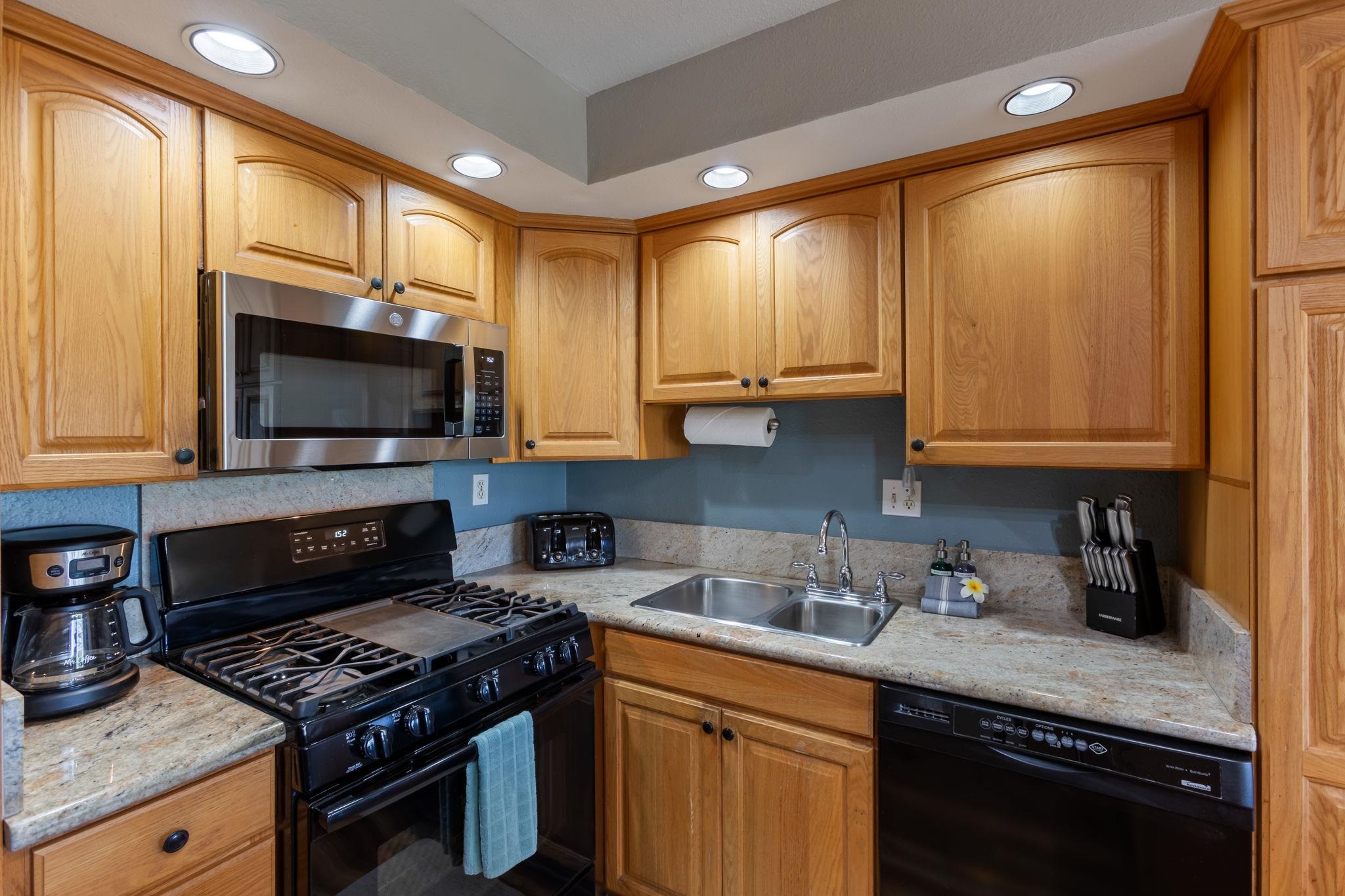 2531 South Kihei Road, Unit C414 Kihei, HI 96753 - Photo 21 of 47 a kitchen with stainless steel appliances granite countertop a stove a sink and a microwave
