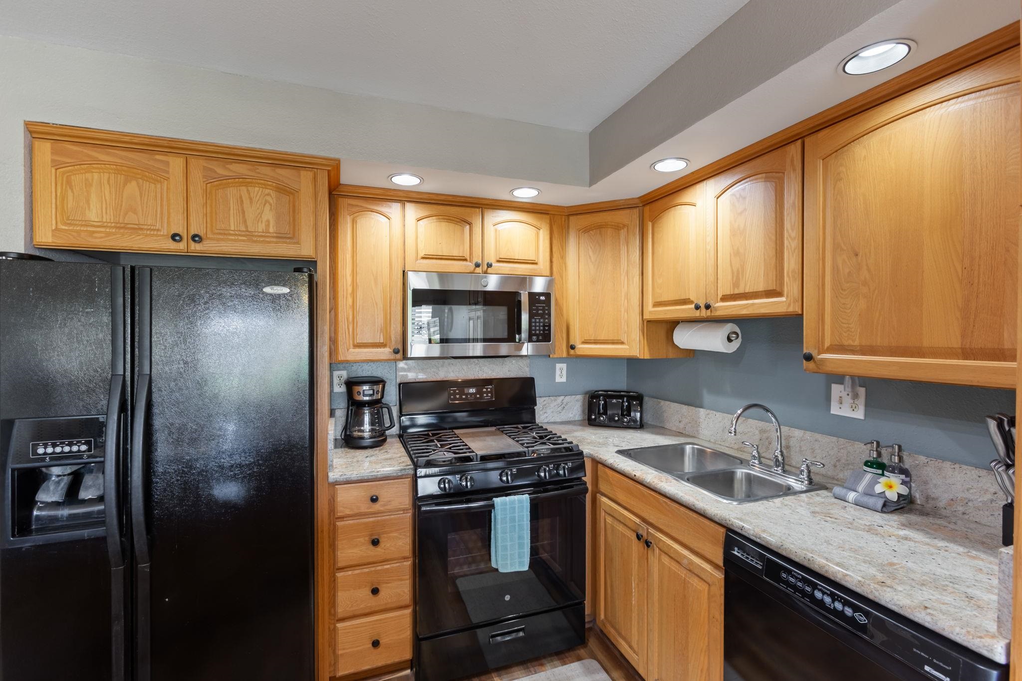 2531 South Kihei Road, Unit C414 Kihei, HI 96753 - Photo 22 of 47 a kitchen with stainless steel appliances granite countertop a refrigerator sink and stove