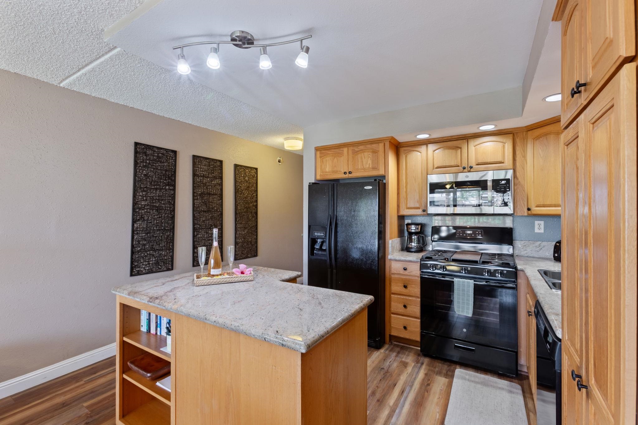 2531 South Kihei Road, Unit C414 Kihei, HI 96753 - Photo 23 of 47 a kitchen with stainless steel appliances granite countertop a refrigerator a stove and a sink