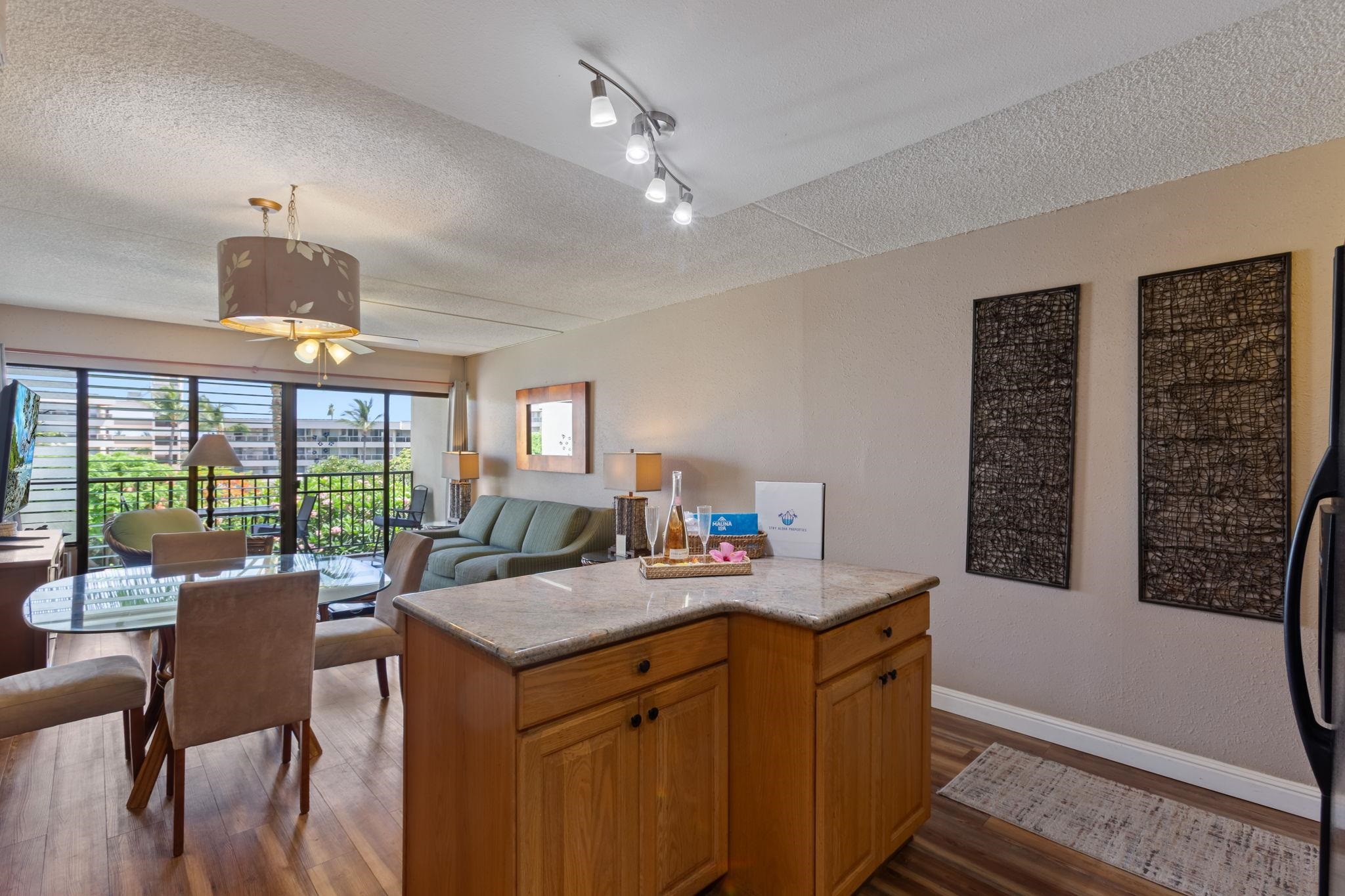 2531 South Kihei Road, Unit C414 Kihei, HI 96753 - Photo 25 of 47 a kitchen with a stove a sink a dining table and chairs