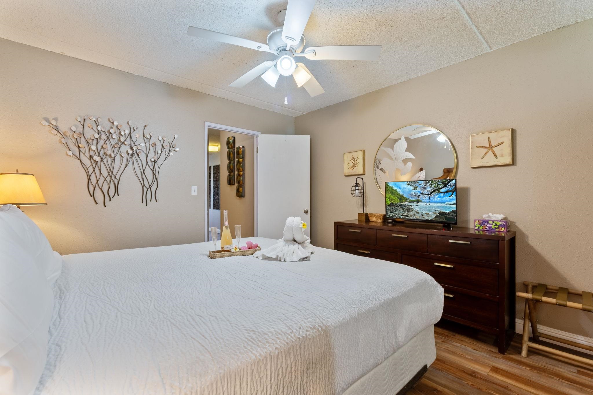 2531 South Kihei Road, Unit C414 Kihei, HI 96753 - Photo 29 of 47 a bedroom with a bed and a chandelier