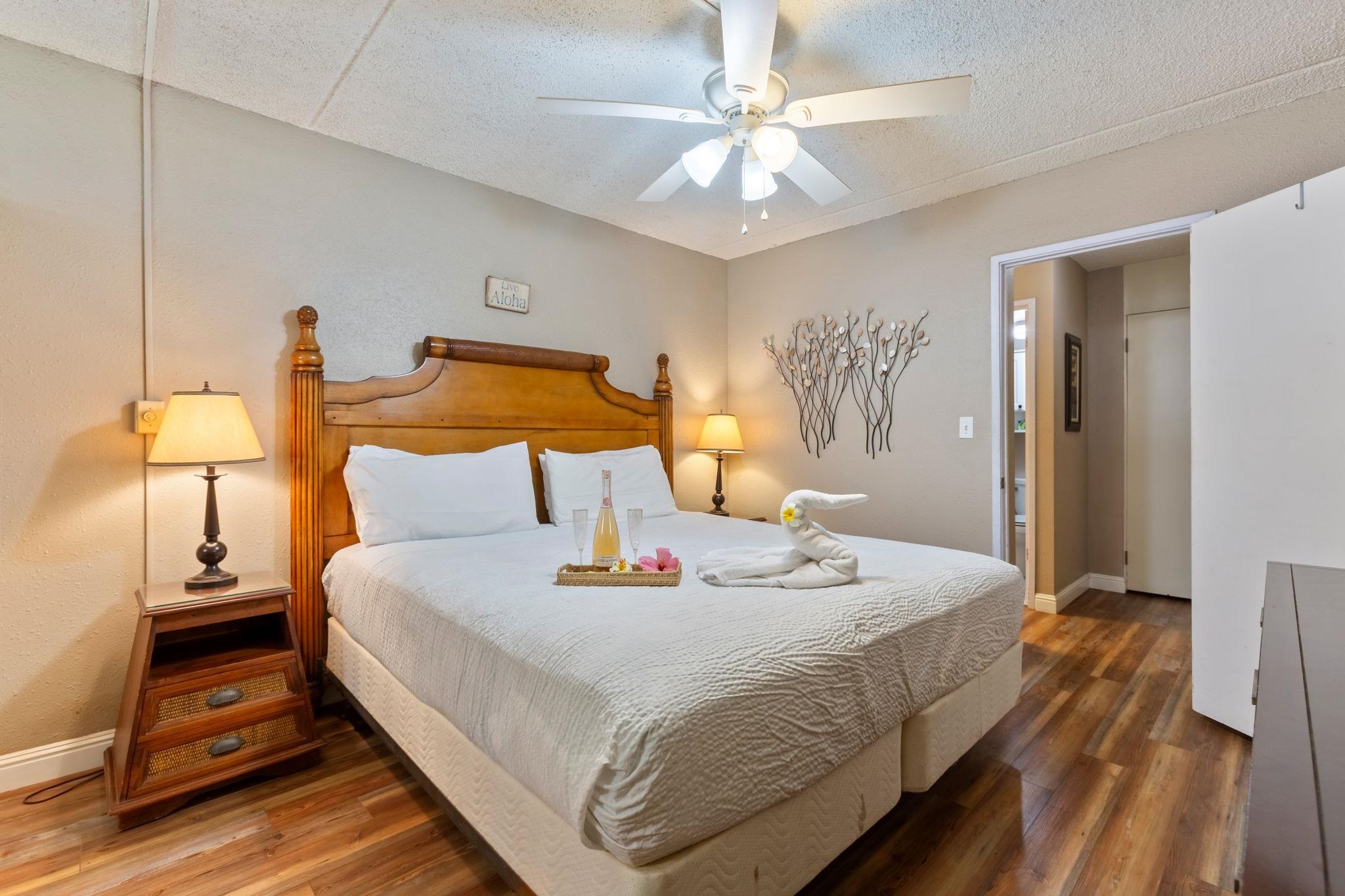 2531 South Kihei Road, Unit C414 Kihei, HI 96753 - Photo 30 of 47 a bedroom with a bed and a chandelier