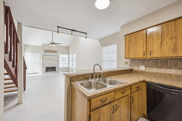 a kitchen that has a sink and a stove
