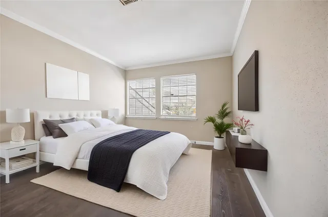 a bedroom with a large bed and a flat screen tv