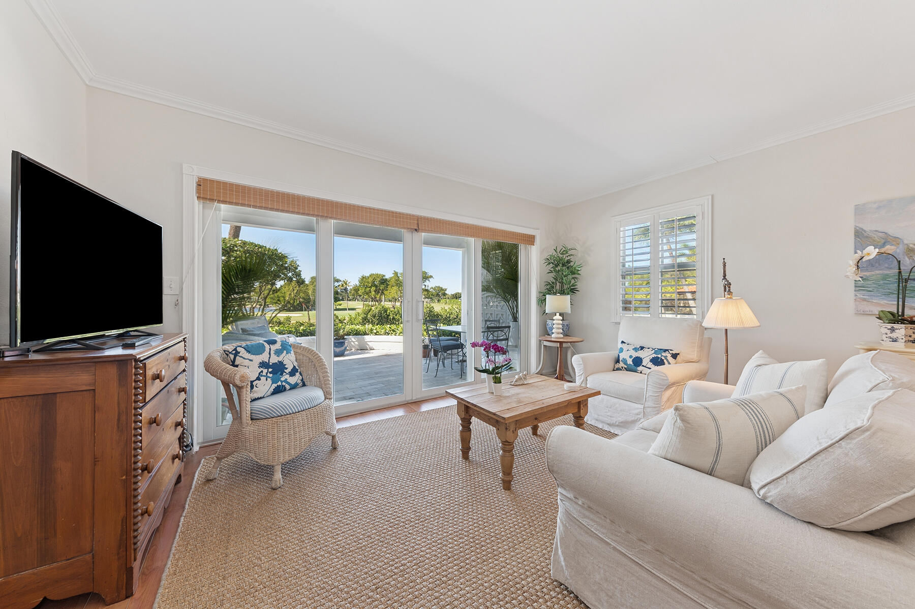 3883 Gulf Stream Road, Unit 1N Gulf Stream, FL 33483 - Photo 5 of 30 a living room with furniture and a flat screen tv