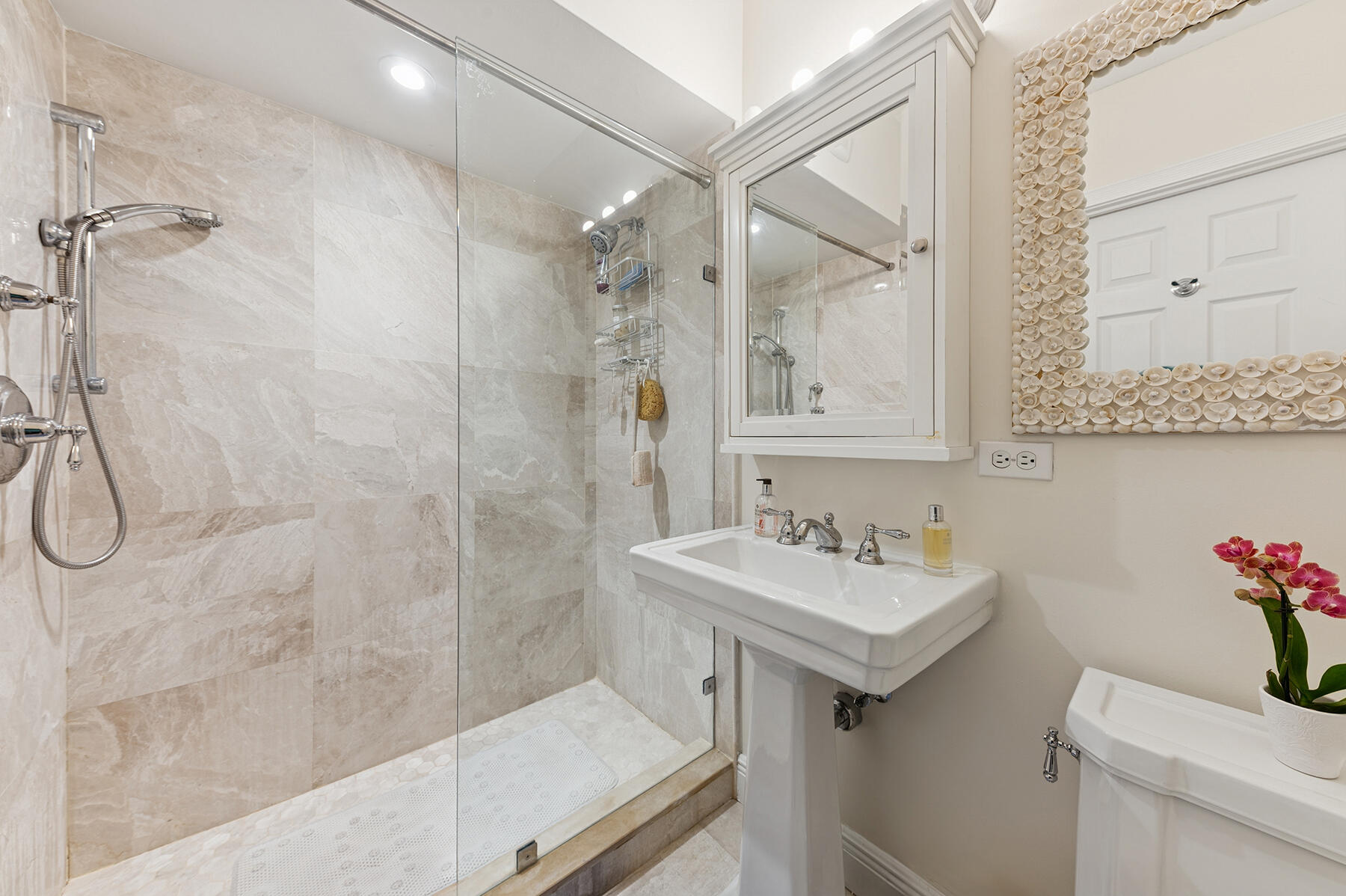 3883 Gulf Stream Road, Unit 1N Gulf Stream, FL 33483 - Photo 10 of 30 a bathroom with a sink and a mirror
