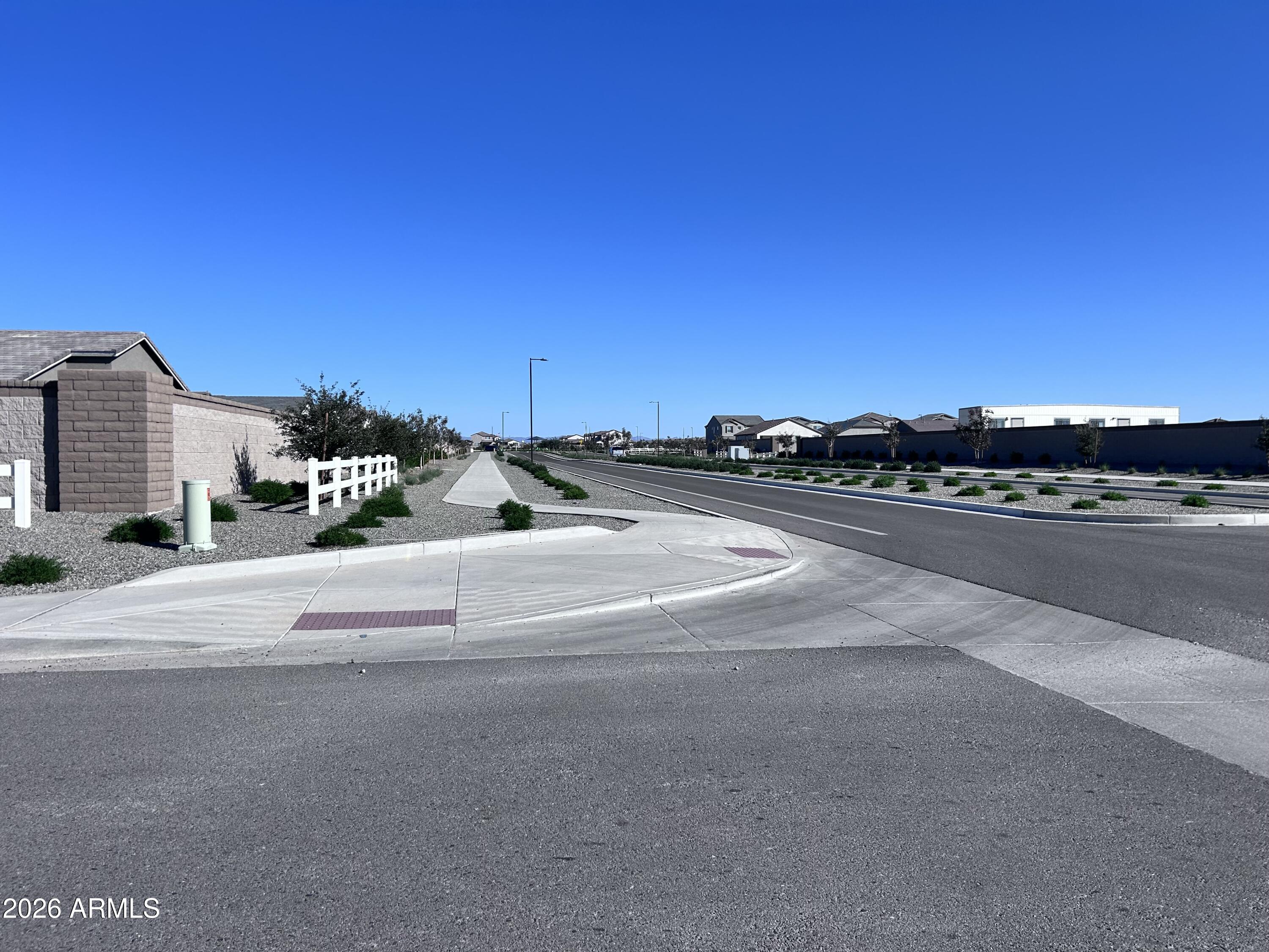 2683 Homesteaders Road San Tan Valley, AZ 85140 - Photo 9 of 21 a view of a road with a building in the background