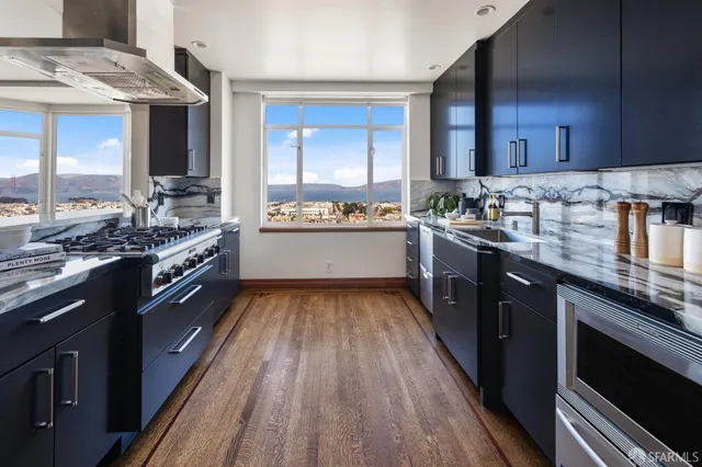 a kitchen with stainless steel appliances granite countertop a sink and stove