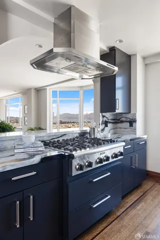 a kitchen with granite countertop stainless steel appliances cabinets a sink and a counter top space