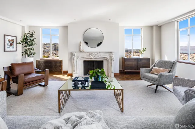 a living room with furniture wooden floor and a large window