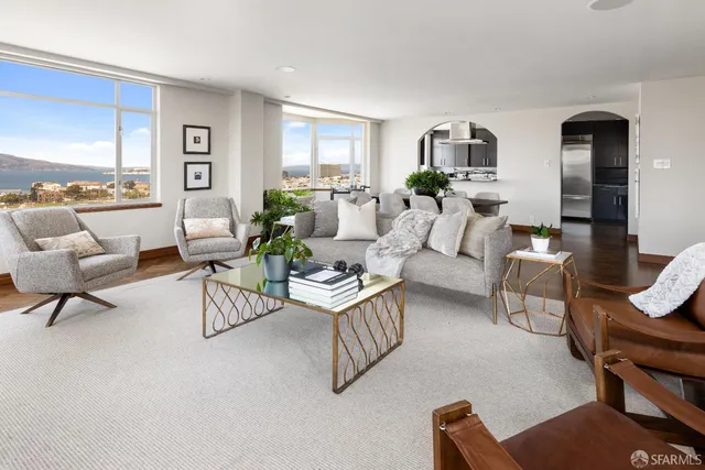 a living room with furniture a fireplace and a large mirror