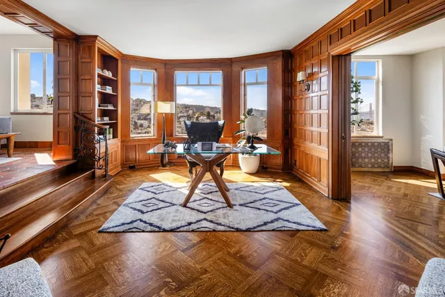a living room with furniture and a mirror