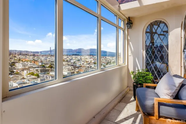 a building outdoor space with patio furniture and potted plants