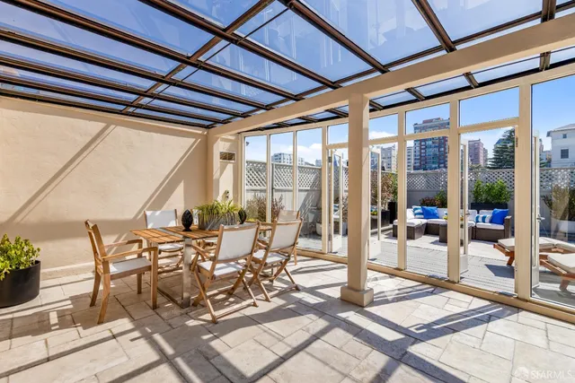 a view of a patio with a dining table and chairs