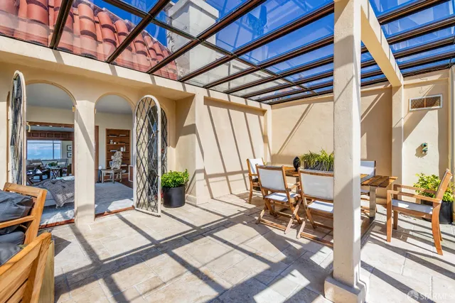 a view of a patio with couches table and chairs and potted plants