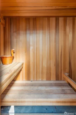 a living room with furniture a fireplace and a large window