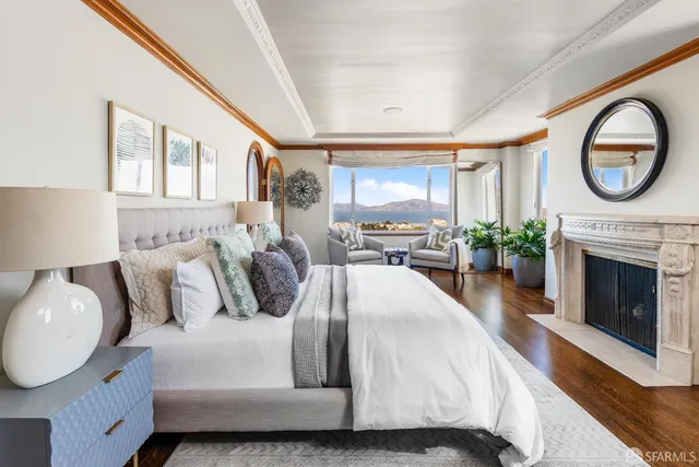 a living room with furniture potted plant and a large window