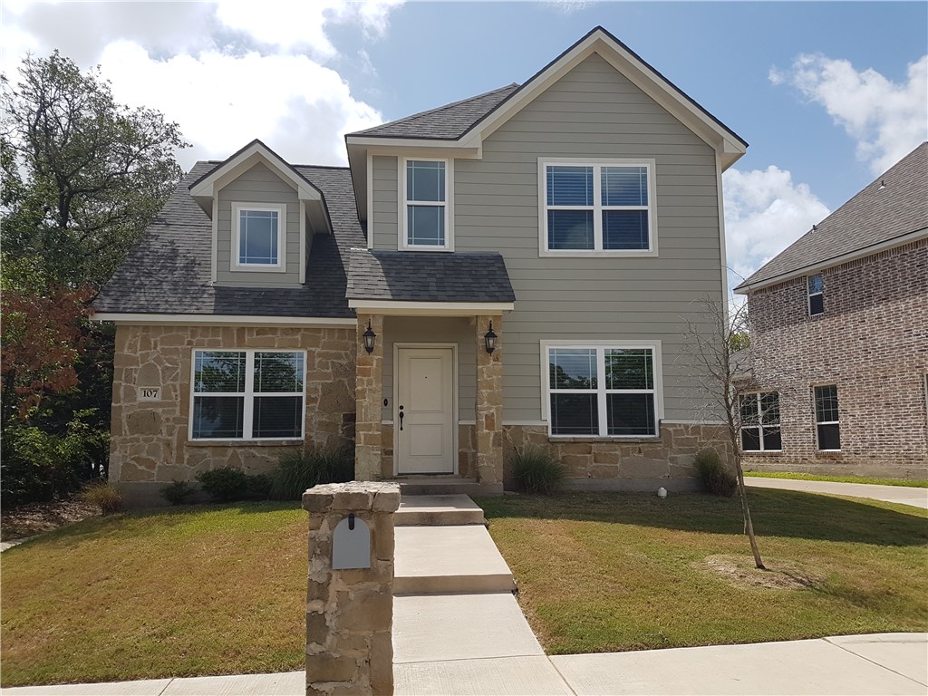 107 Ehlinger Drive Bryan, TX 77801 - Photo 1 of 50 a front view of a house with garden
