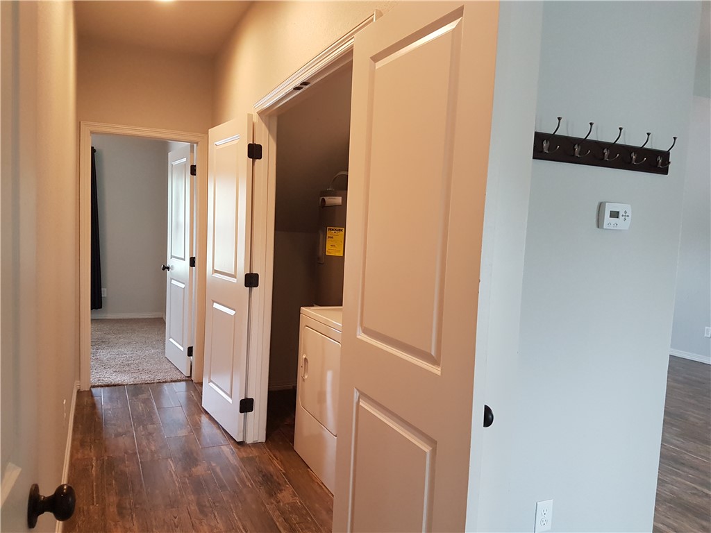 107 Ehlinger Drive Bryan, TX 77801 - Photo 16 of 50 a view of a hallway with wooden floor and cabinet