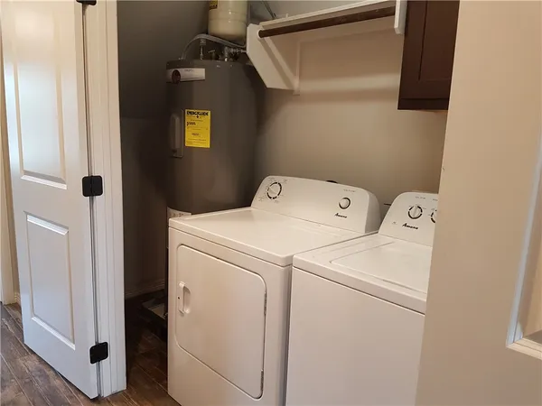a bathroom with a granite countertop sink a toilet a mirror and vanity