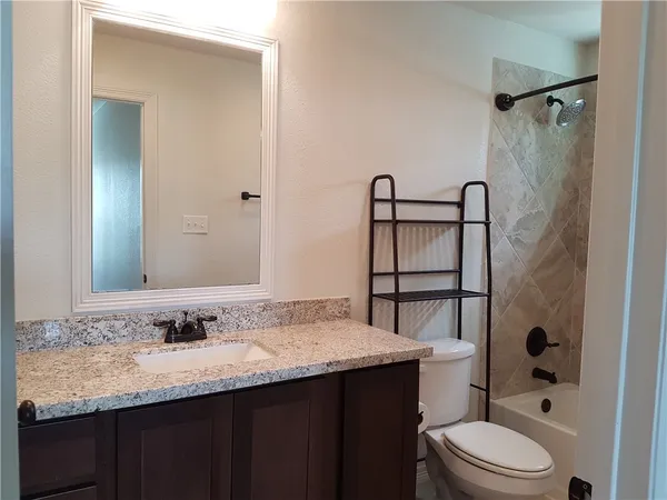 a bathroom with a bathtub and toilet