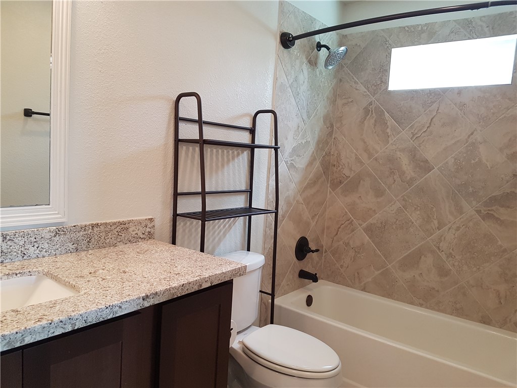 107 Ehlinger Drive Bryan, TX 77801 - Photo 27 of 50 a bathroom with a granite countertop sink toilet and shower