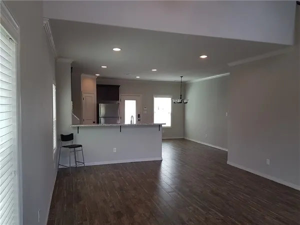 a view of wooden floor and windows in an empty room