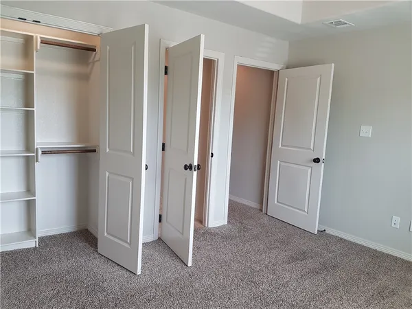 a view of a bathroom from a corridor