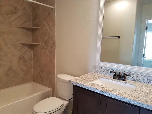 a view of a backyard with wooden fence