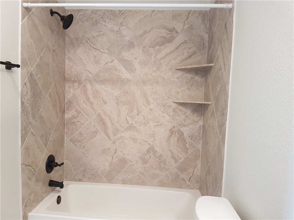 107 Ehlinger Drive Bryan, TX 77801 - Photo 34 of 50 a bathroom with a bathtub and toilet