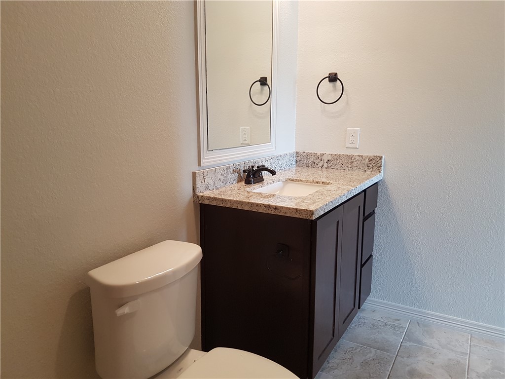 107 Ehlinger Drive Bryan, TX 77801 - Photo 35 of 50 a bathroom with a sink a toilet and a mirror