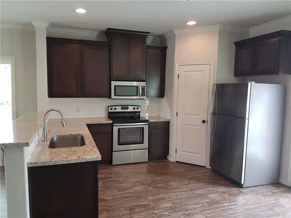 107 Ehlinger Drive Bryan, TX 77801 - Photo 5 of 50 a kitchen with a refrigerator sink and microwave
