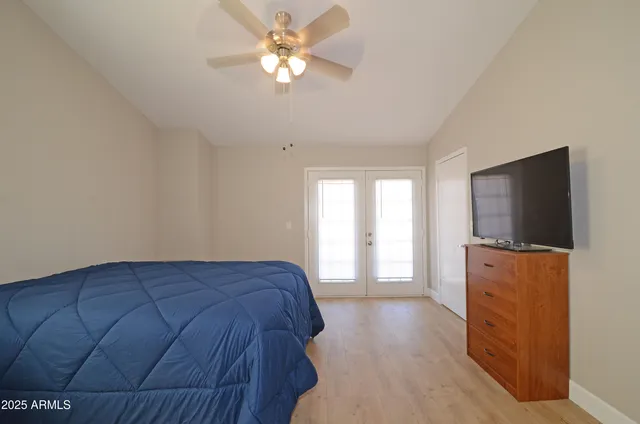 a bedroom with a bed and a flat screen tv