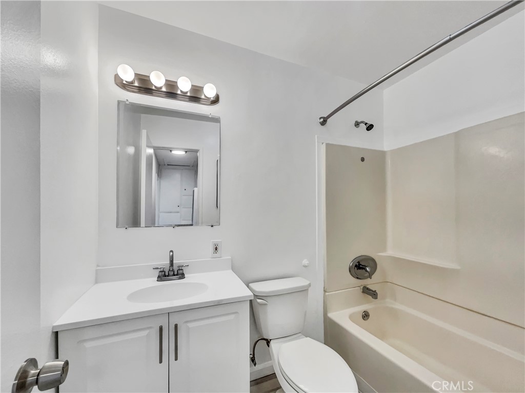 1920 North H Street, Unit 251 Oxnard, CA 93036 - Photo 10 of 19 a bathroom with a sink a toilet and shower