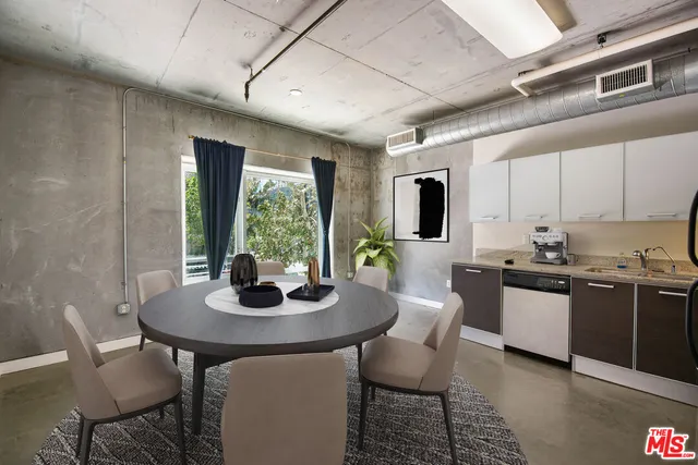 a kitchen with a dining table and chairs