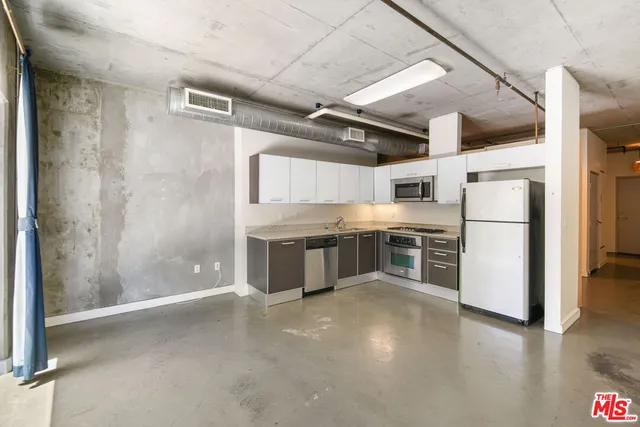 a kitchen with stainless steel appliances a refrigerator and a stove