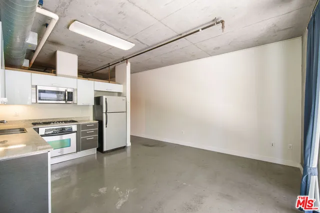 a kitchen with stainless steel appliances a refrigerator and a stove