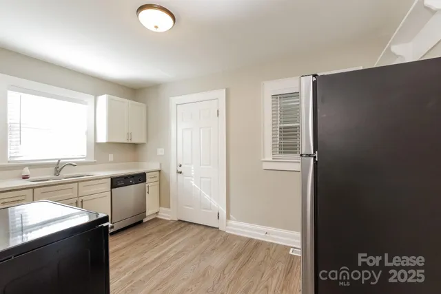a kitchen with a refrigerator and a sink