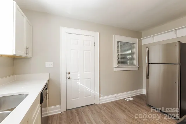 a kitchen with a refrigerator sink and cabinets