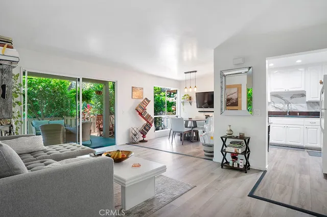 a living room with furniture large window and flat screen tv