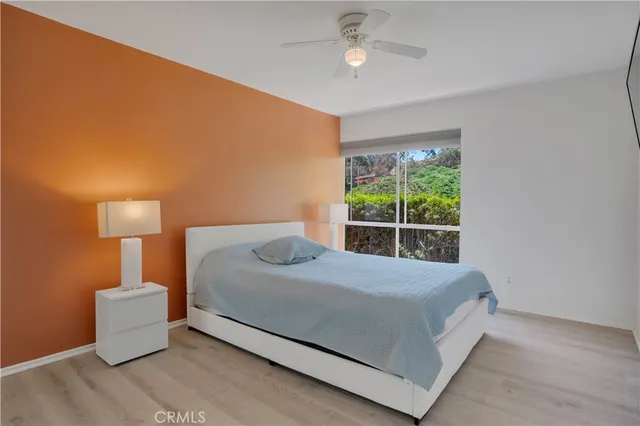 a bedroom with a bed and a lamp