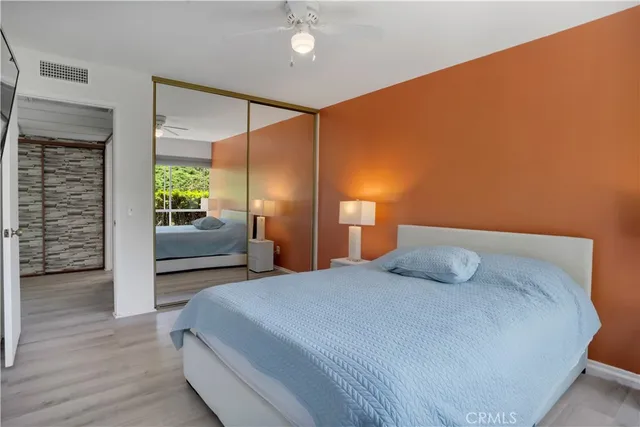 a bedroom with a bed and a potted plant