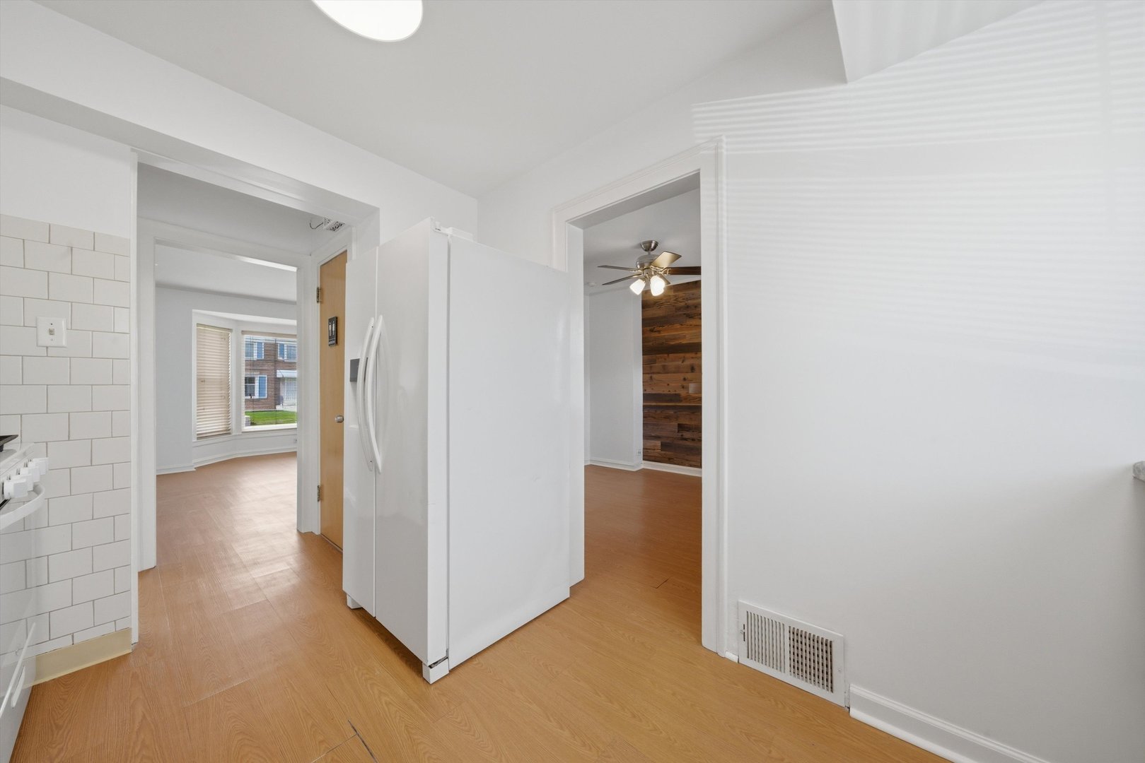 3941 North Mobile Avenue Chicago, IL 60634 - Photo 11 of 46 a view of a hallway with wooden floor and a living room