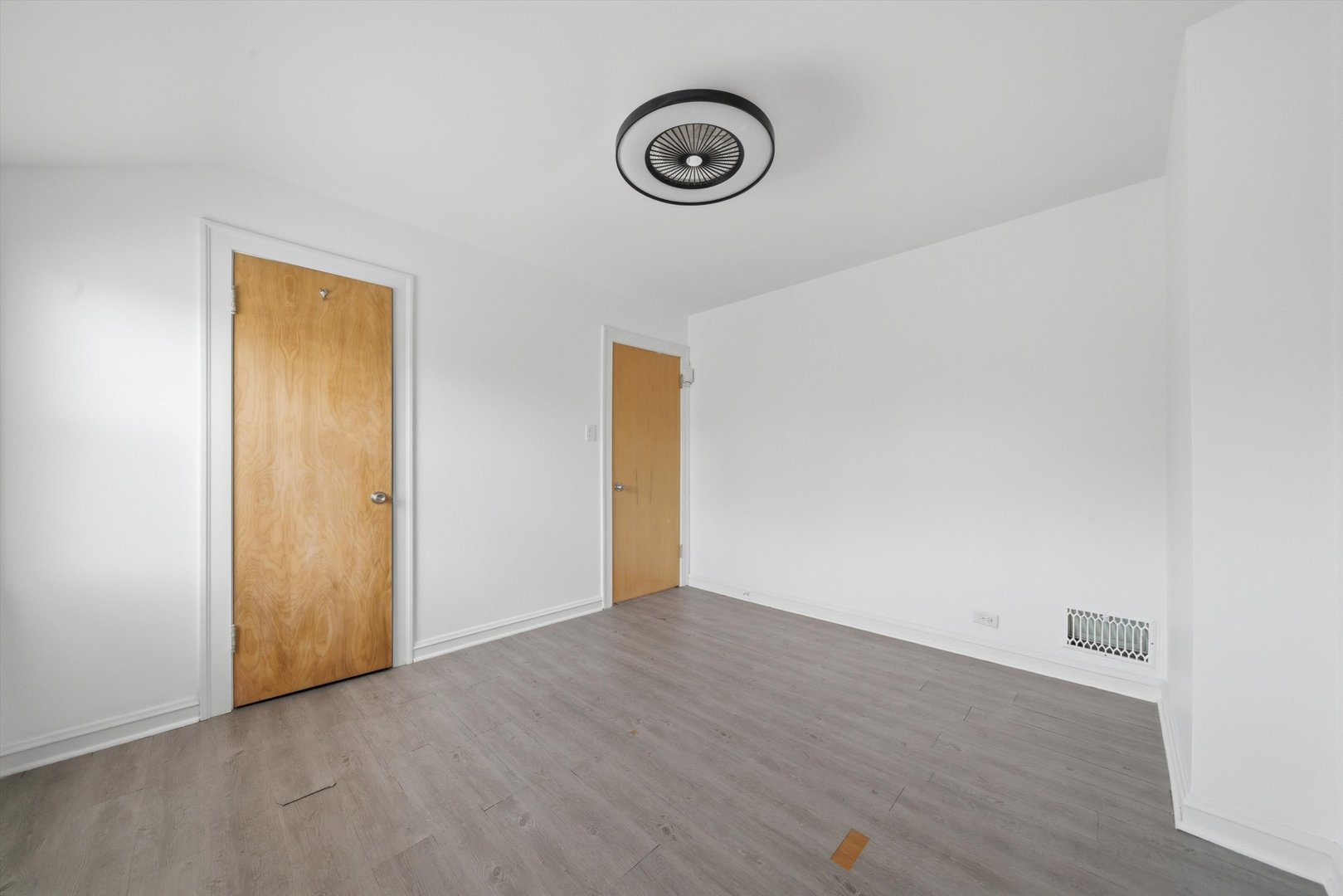 3941 North Mobile Avenue Chicago, IL 60634 - Photo 19 of 46 a view of an empty room with wooden floor and a window