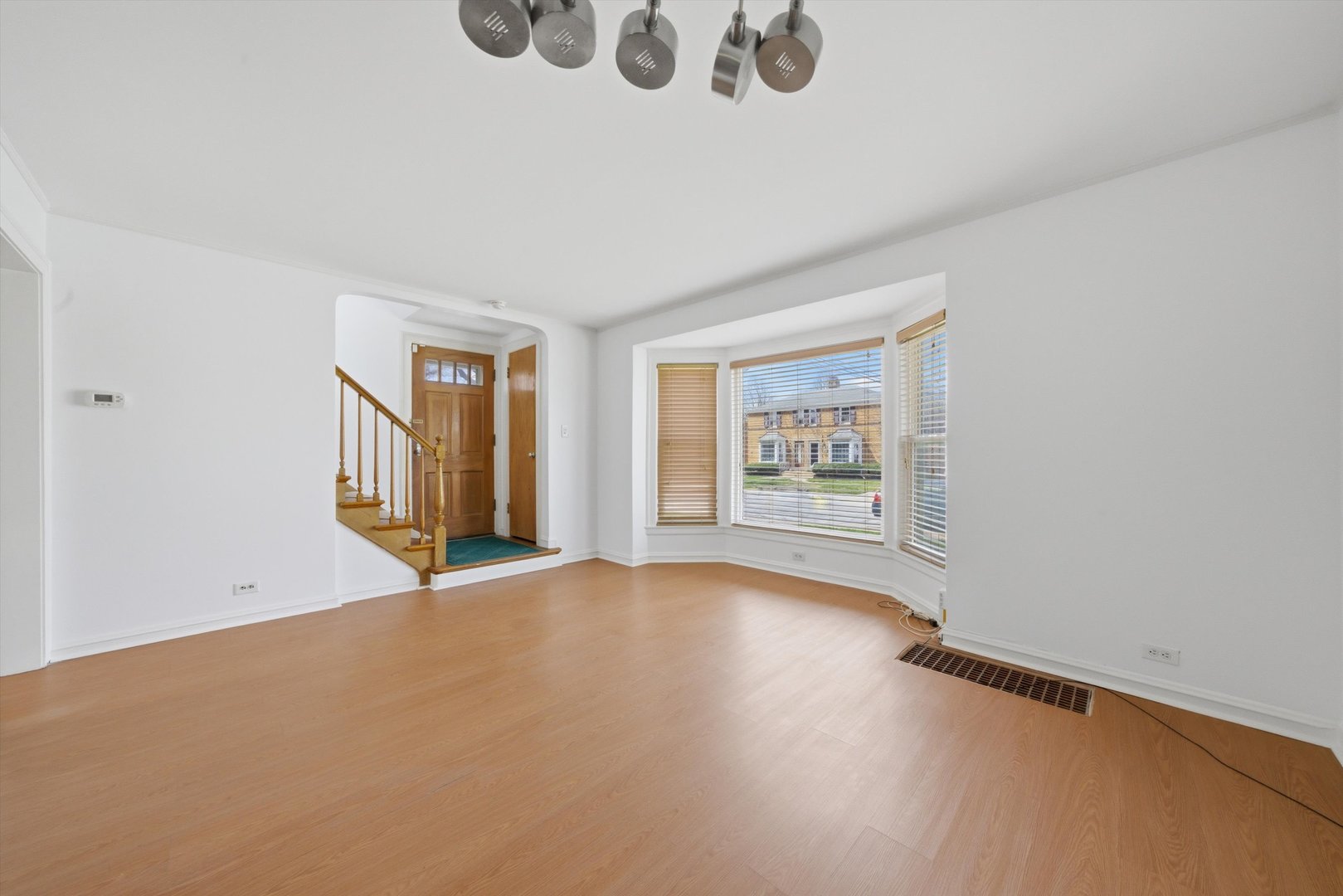 3941 North Mobile Avenue Chicago, IL 60634 - Photo 5 of 46 wooden floor in an empty room with a window