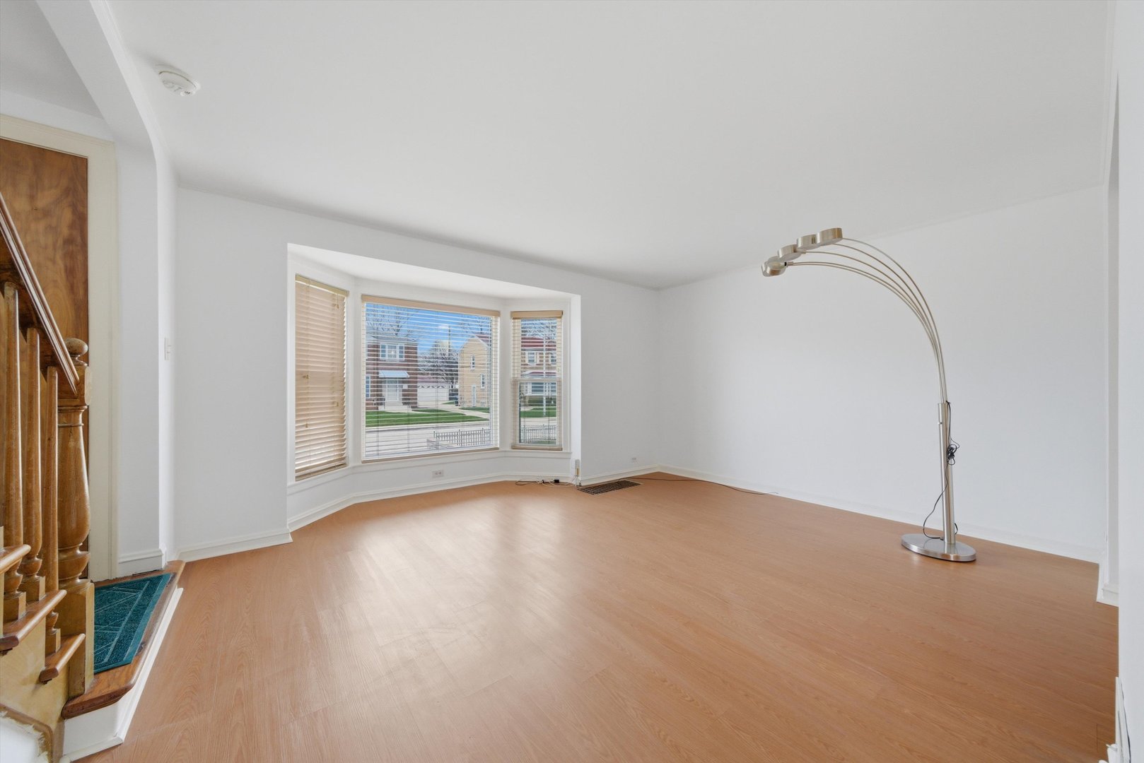 3941 North Mobile Avenue Chicago, IL 60634 - Photo 7 of 46 an empty room with wooden floor and windows
