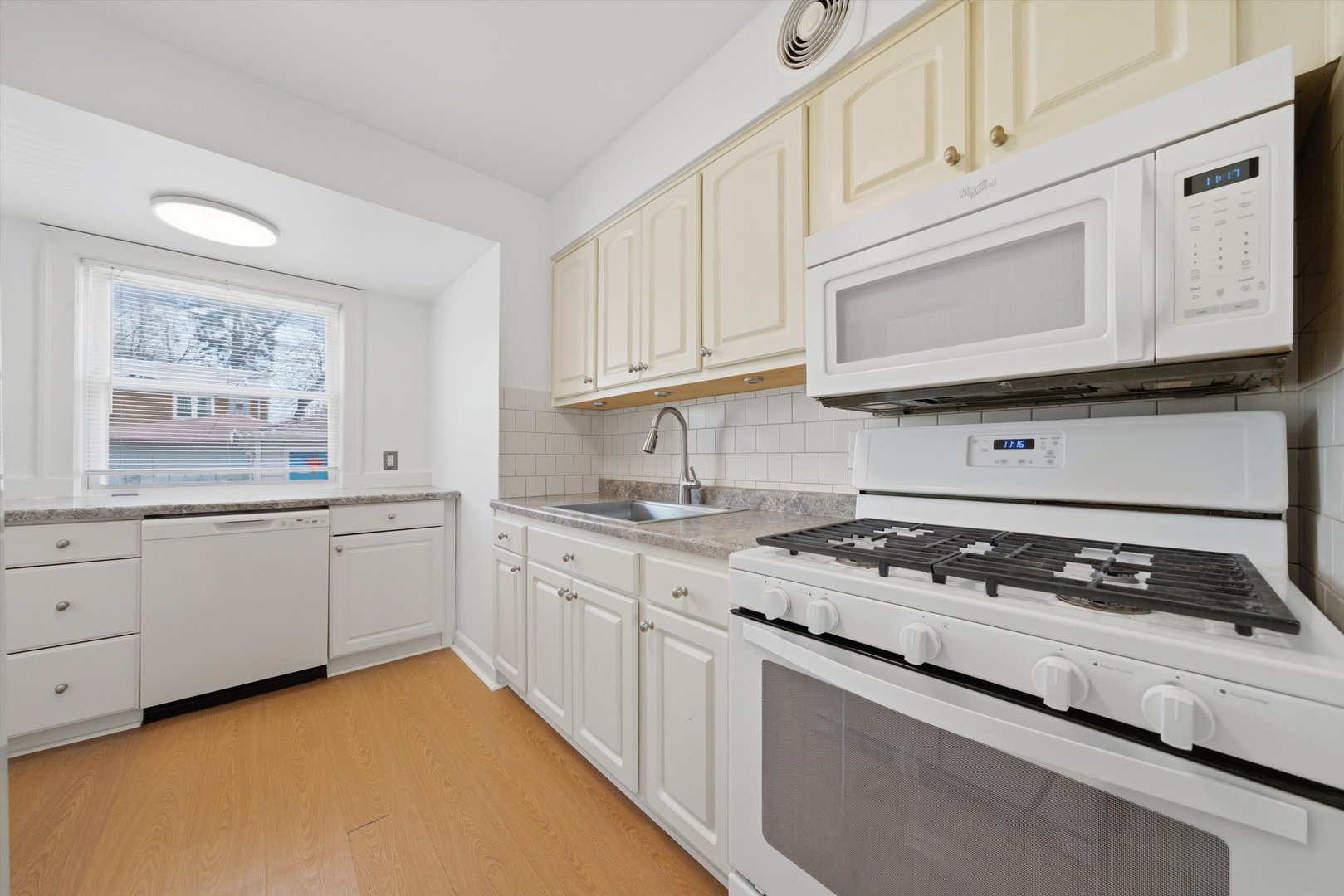 3941 North Mobile Avenue Chicago, IL 60634 - Photo 9 of 46 a kitchen with granite countertop cabinets stove top oven and sink